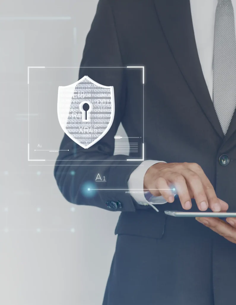 A person in a suit holding a tablet with a digital shield and lock icon, symbolizing cybersecurity and data protection.