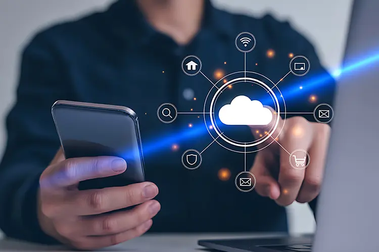 Person using a smartphone with a digital cloud and app icons, representing cloud computing and data connectivity.