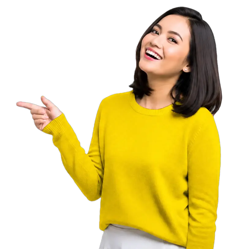 Woman in a yellow sweater smiling and pointing to her left against a plain white background.